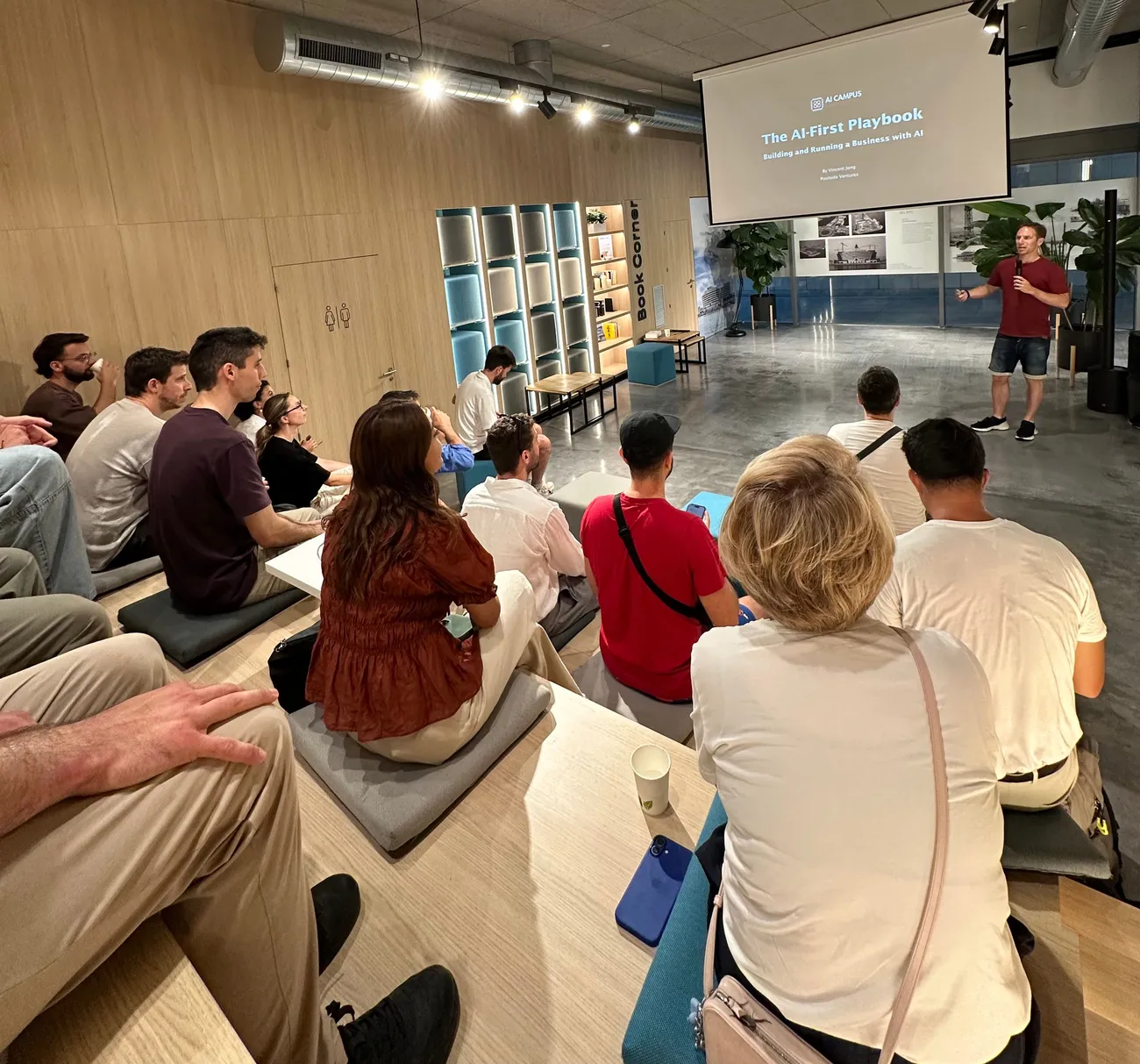 Founder presenting The AI-First Playbook to a seated audience at an AI Campus session.